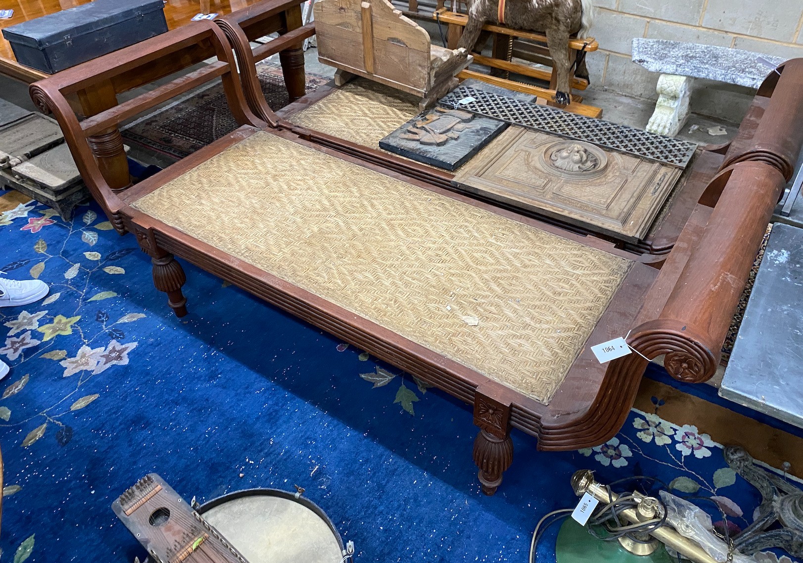 An Asian hardwood day bed with caned seat, width 212cm depth 71cm